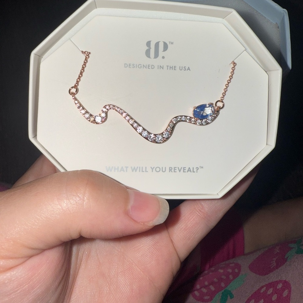 BP Gold and Blue Necklace with Elegant Wave Design